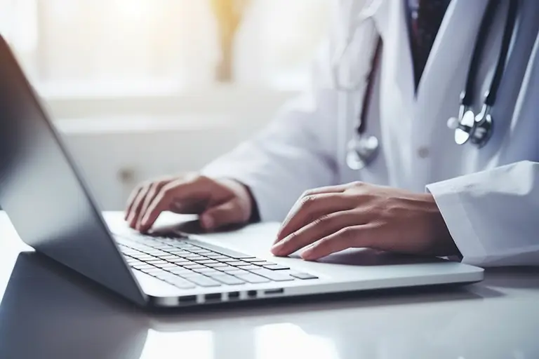Doctor working on a laptop computer